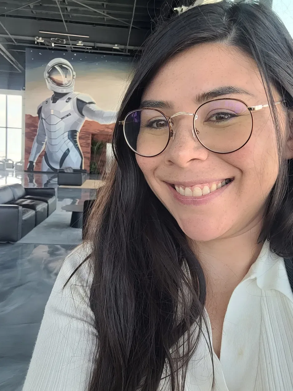 Ana Rosa Lerma smiling, wearing round glasses